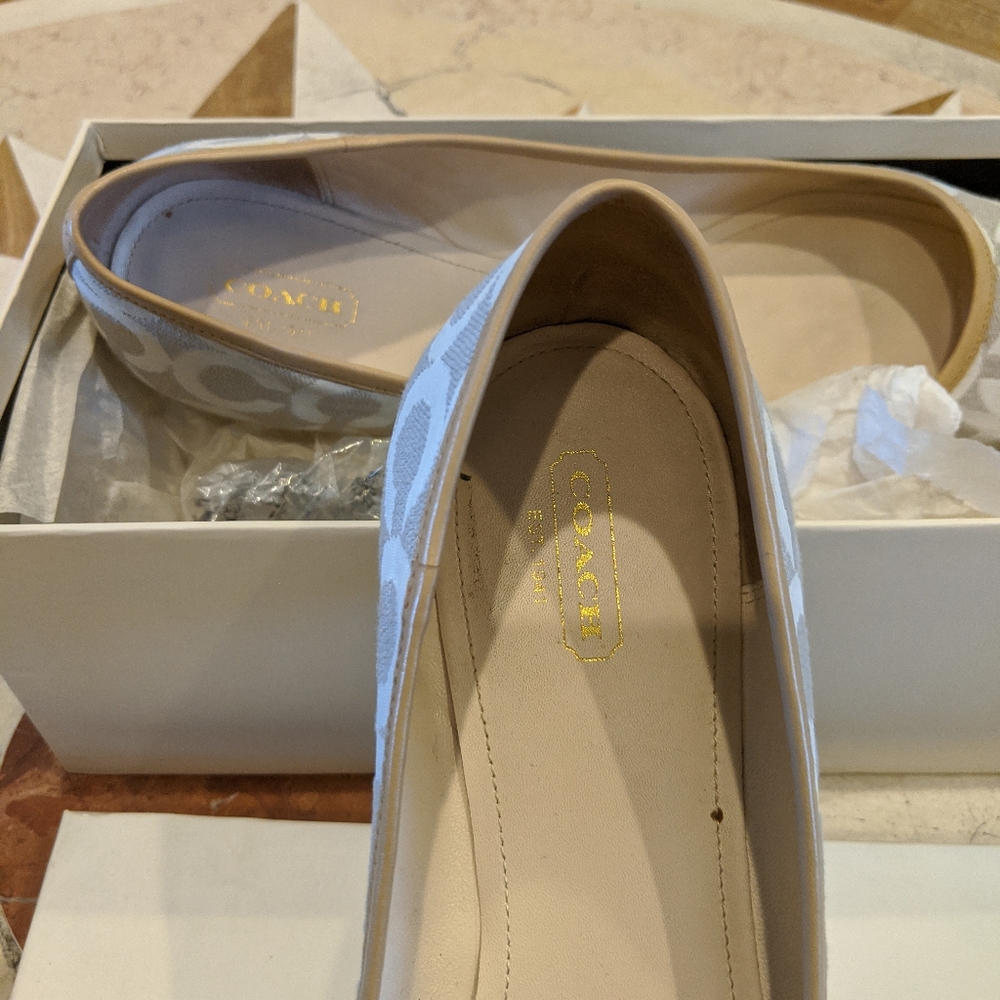 Beige and white Coach logo flats